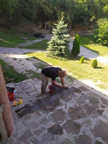 Паломник ремонтирует ступени к келиям монастыря Сурб Хач